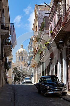 View of oldtimer car with colonial balconies and the ancient palace of the dictator Batista now the revolution museum photo