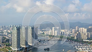 View of one of the districts of Sanya city. Visible are the skyscrapers and the public ferry terminal. Hainan, China