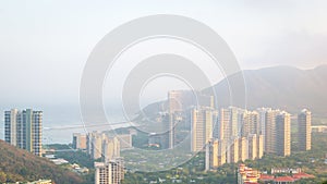 View of one of the districts of Sanya city. Visible are the skyscrapers. Sunset, blur, haze. Hainan Island, China