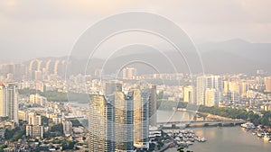 View of one of the districts of Sanya city. Visible are the skyscrapers. Sunset, blur, haze. Hainan Island, China