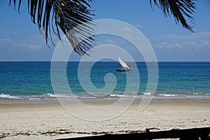 View onto the beach and a Dhow in the water from a cafe in Stone Town, Zanzibar