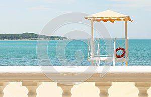 View of the open blue sea on the background of the white parapet and the observation deck of the lifeguard.