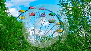 View of open colored Ferris wheel booths of the city park