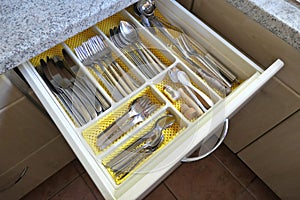 View of an open cutlery drawer in a kitchen