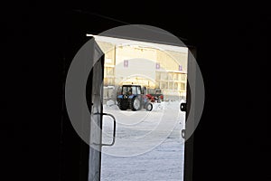 View through open door on tractor removes snowCold winter