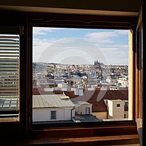 View through a open window over the old town of Prague