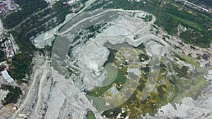 View of opencast mining quarry with lots of machinery. Mining in the granite quarry. Working mining machine - digger, drilling mac