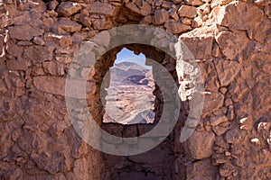 A view through an opening in a stone wall