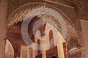 View of an orange building's interior arch of the Al-Attarine Madrasa in Marocco