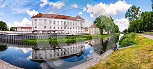 View of Oranienburg Castle with the banks of the river Havel in the foreground