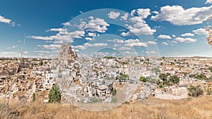 View of Ortahisar town old houses in rock formations from Ortahisar Castle aerial timelapse.