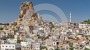 View of Ortahisar town old houses in rock formations from Ortahisar Castle aerial timelapse.