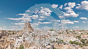 View of Ortahisar town old houses in rock formations from Ortahisar Castle aerial timelapse.