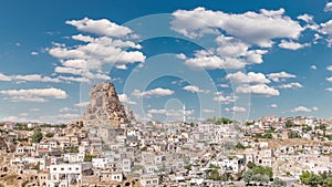 View of Ortahisar town old houses in rock formations from Ortahisar Castle aerial timelapse.