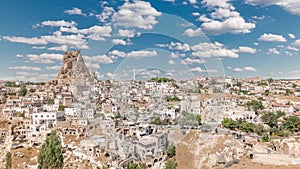 View of Ortahisar town old houses in rock formations from Ortahisar Castle aerial timelapse.