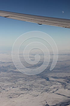 View out of an Airplane - Frozen Wasteland and Moon