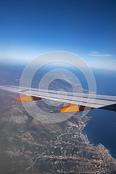 View out of a flying plane to the wing and the coast near Nizza photo