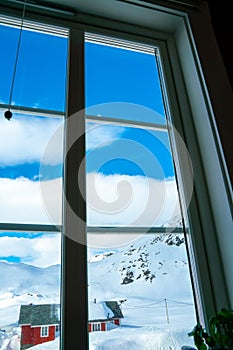 View out the window of snow capped mountains on a cold winters day