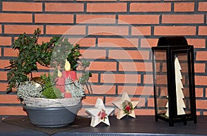 View on an outdoor christmas decoration with candle and plant and wooden stars at home in niederlangen emsland germany