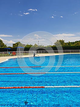 View  outdoor pool with swimming lanes on summer sunny holiday day