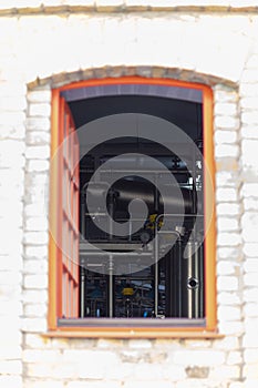 View from the outside through the window of the equipment and industrial tools for the production of brewery