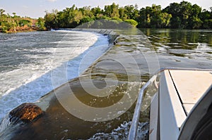 View outside window of offroad truck driving the Ivanhoe Crossing, Kununurra, Western Australia, Australia. A concrete causeway