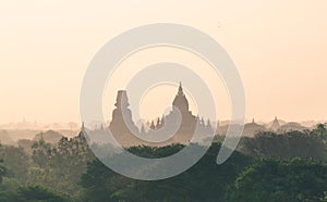 View over ancient temples of Bagan during sunrise golden hour in Myanmar