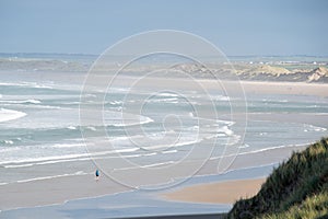 view over the beach of Barrow with lonely person standing in the water of the Atlantic Ocean