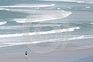 view over the beach of Barrow with lonely person standing in the water of the Atlantic Ocean