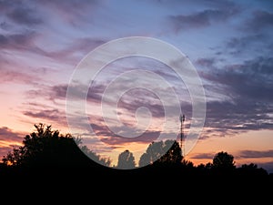 View over a beautiful sunset behind a radio antenna tower