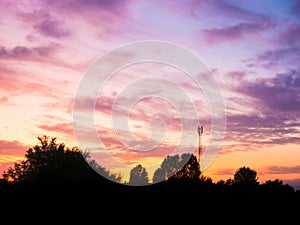 View over a beautiful sunset behind a radio antenna tower