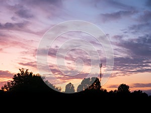 View over a beautiful sunset behind a radio antenna tower