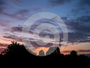 View over a beautiful sunset behind a radio antenna tower