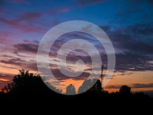 View over a beautiful sunset behind a radio antenna tower