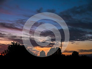 View over a beautiful sunset behind a radio antenna tower