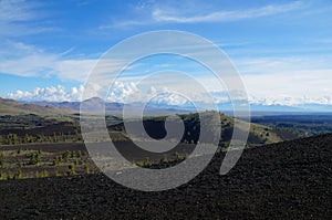 View over a black volcanic lava landscape from the Inferno Cone