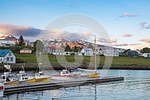 View over the boats in port of hrisey in Iceland towards the village