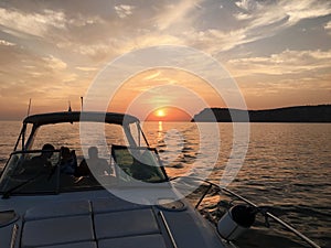 View over the bow of a large luxury motor yacht with bridge area on tropical open sea with mountains