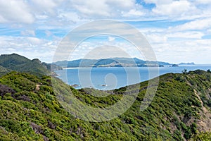 View over bushclad hills of Great Barrier Island to bays and sea