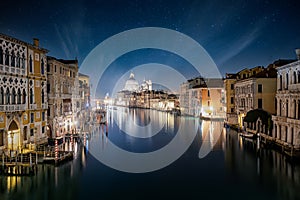 View over the Canal Grande to the illuminated cityscape of Venice, Italy