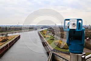 View over canals near Magdeburg with coin-operated binoculars in blurred foreground