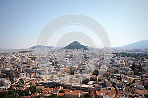 View over the city and the Lycabettus hill from Acropolis in Athens, Greece. Panorama of Athens . Beautiful cityscape