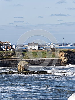 View over Collywell Bay with Charlie\'s Garden rock formation to Seaton Sluice and Blyth, Northumberland, UK photo