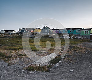 View over colourful greenland houses of Disko Island, arctic city of Qeqertarsuaq. Located in the disko bay. Blue sky photo