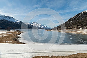 View over the frozen lake of Silvaplana and the peak of the mount Corvatsch in the background