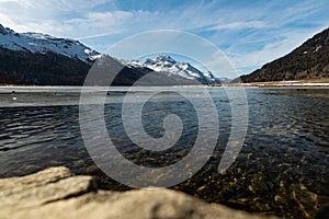 View over the frozen lake of Silvaplana and the peak of the mount Corvatsch in the background