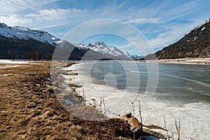 View over the frozen lake of Silvaplana and the peak of the mount Corvatsch in the background