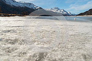 View over the frozen lake of Silvaplana and the peak of the mount Corvatsch in the background