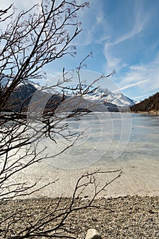 View over the frozen lake of Silvaplana and the peak of the mount Corvatsch in the background