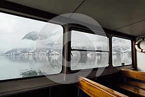 View over Hallstatt town and Alps mountains from inside the ferry